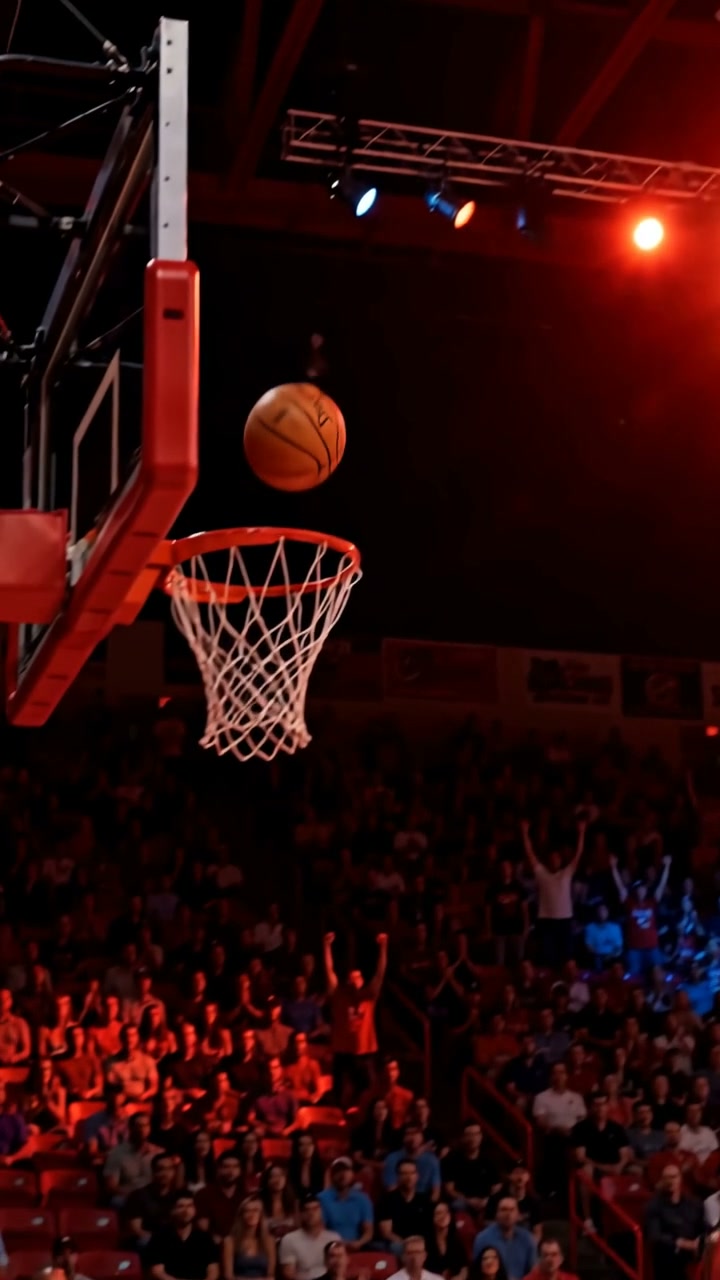 A basketball suspended near the hoop at the decisive moment of a shot